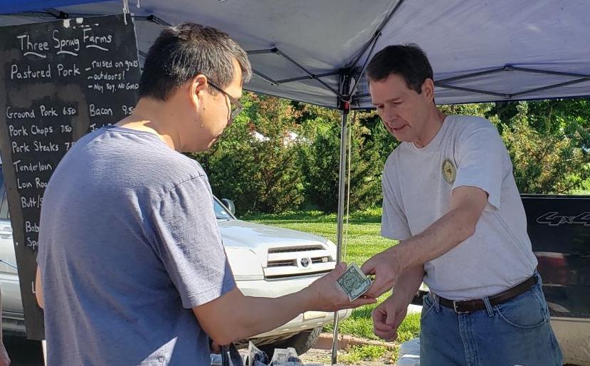 Dr. Bryan Meyers, left, selling to Geoff Uy